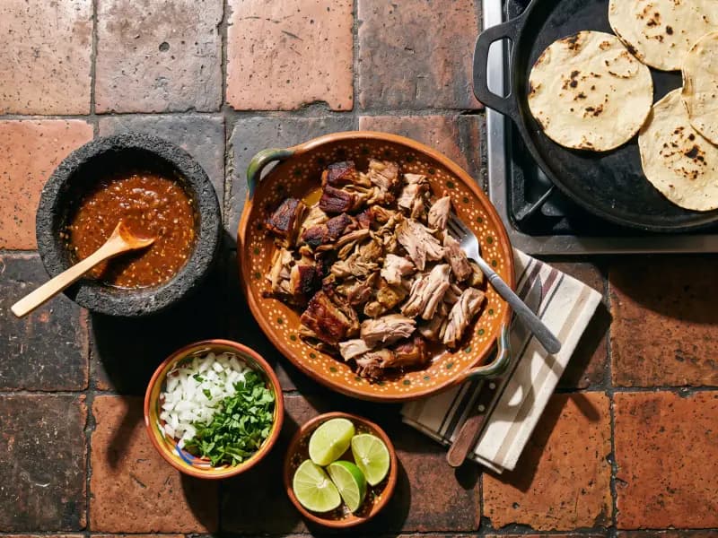Carnitas — shot from directly overhead: pork shoulder simmered in its own fat until it falls apart