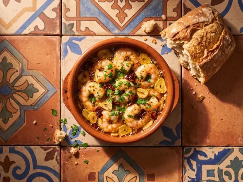 Gambas al Ajillo — shot from directly overhead: prawns cooked hard in garlic oil with chilli