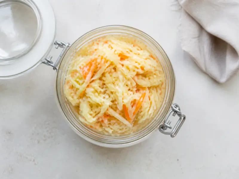 Sauerkraut — shot from directly overhead: cabbage and carrot salted