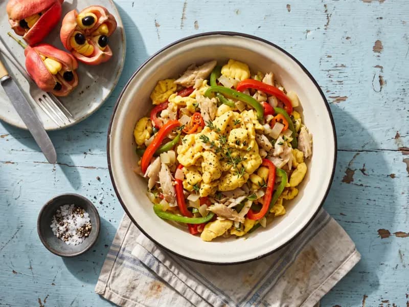 Ackee and Saltfish — shot from directly overhead: salt cod soaked and flaked into sautéed onion and pepper