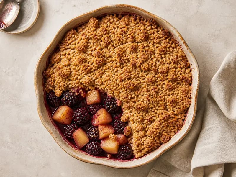 Apple and Blackberry Crumble — shot from directly overhead: tart Bramley apples and blackberries under a rubbed-in oat crumble