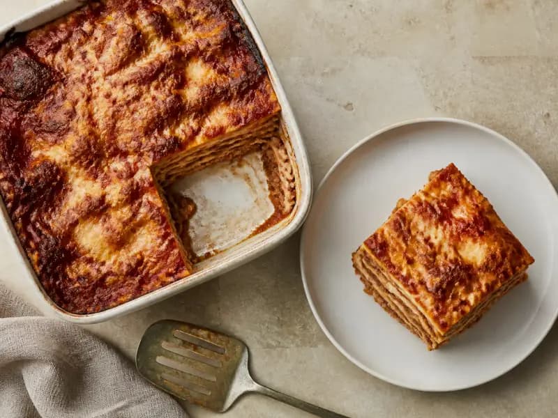 Baked Lasagne — shot from directly overhead: ragu and béchamel layered thin between dried pasta sheets