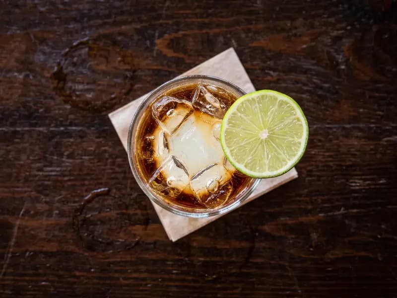 Dark and Stormy — shot from directly overhead: ginger beer and lime with dark rum floated on top