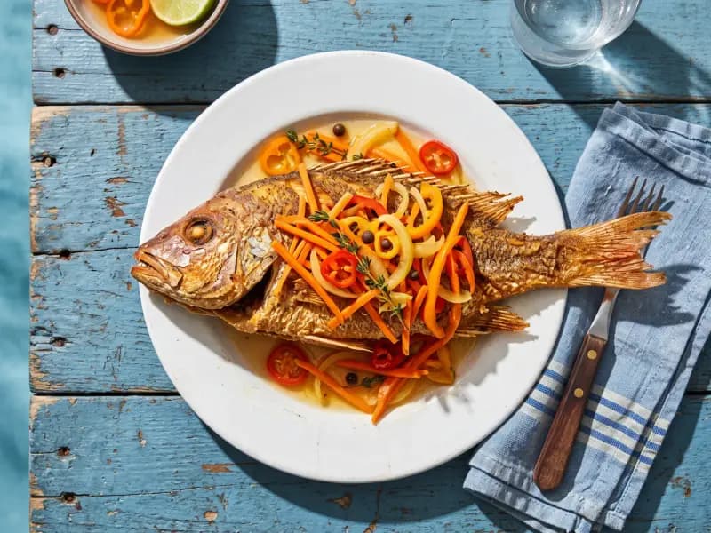Escovitch Fish — shot from directly overhead: whole fish fried until the skin shatters