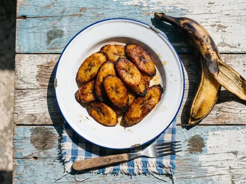 Fried Plantain — shot from directly overhead, the table surface filling the frame