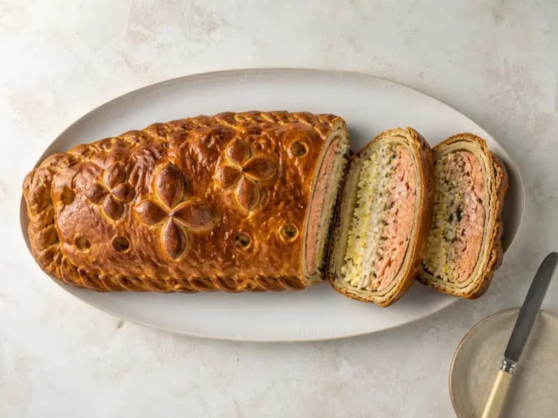 Kulebyaka — shot from directly overhead: an enriched pastry loaf layered with salmon
