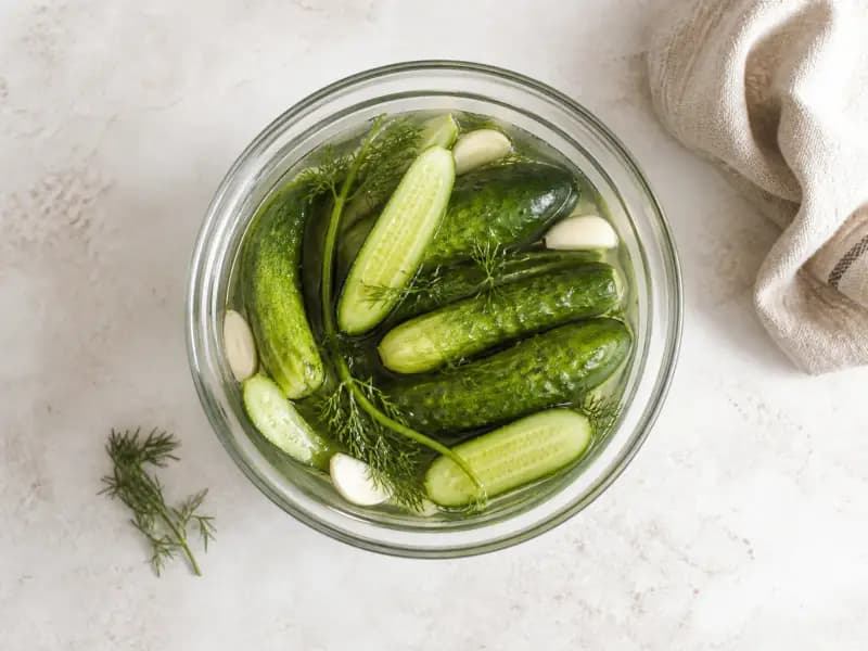 Quick Salted Cucumbers — shot from directly overhead: small cucumbers held a day or two in a dill and garlic brine