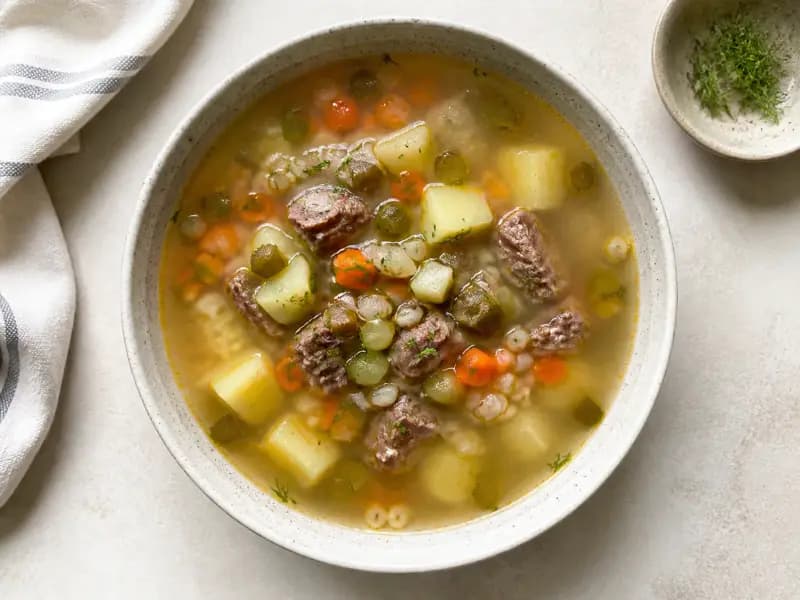 Rassolnik — shot from directly overhead: barley and pickled cucumber soup