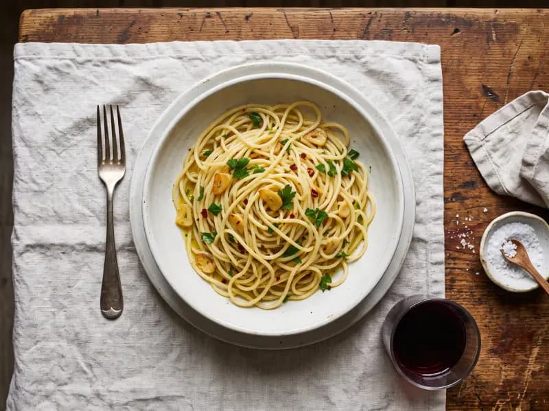 Spaghetti Aglio e Olio — shot from directly overhead: garlic sliced thin and taken slowly to pale gold in olive oil